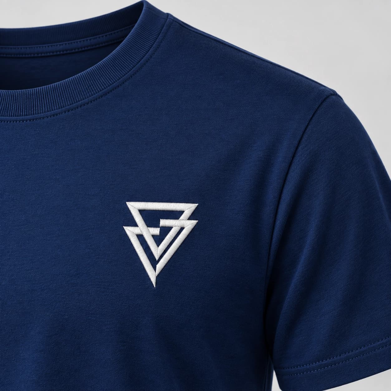 A gola, o ombro e o símbolo bordado no peito da Camiseta OLS azul